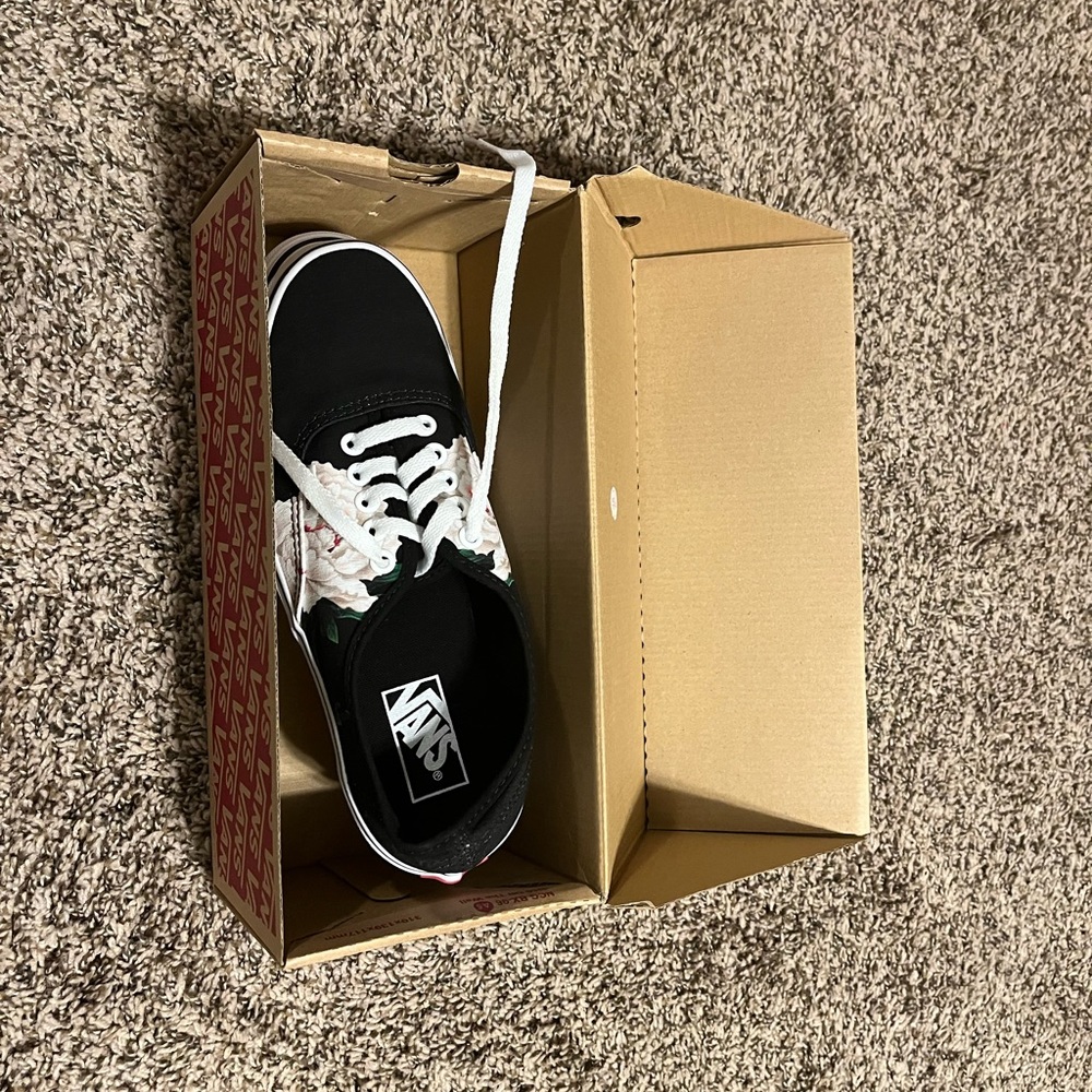 Black vans with floral details